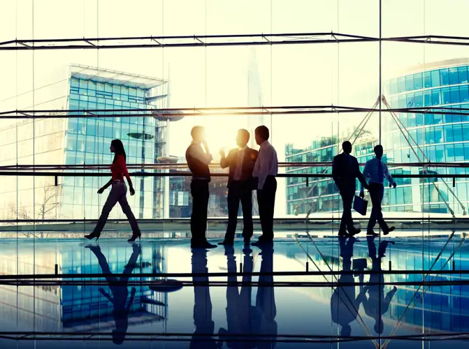 Business office people standing and talking others walking on by