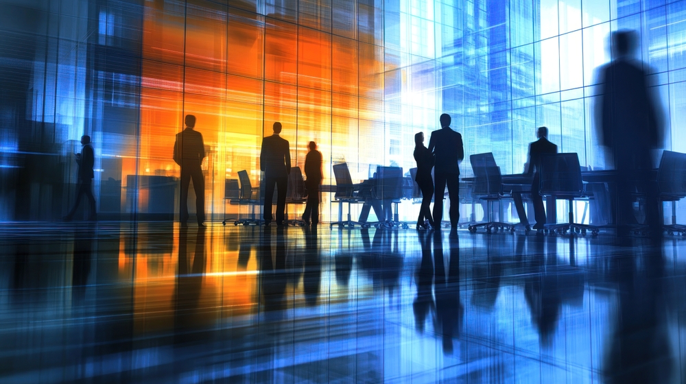 Office orange glow with people at desks and stood around