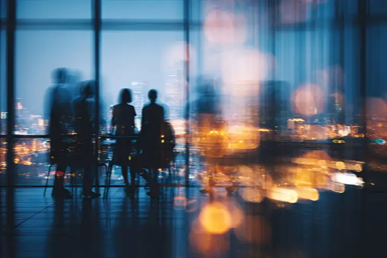 Blurry image of people in an office meeting room