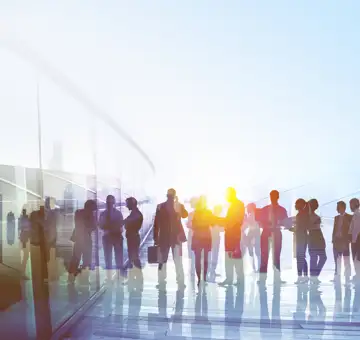 Silhouettes of people outside some light up in yellow