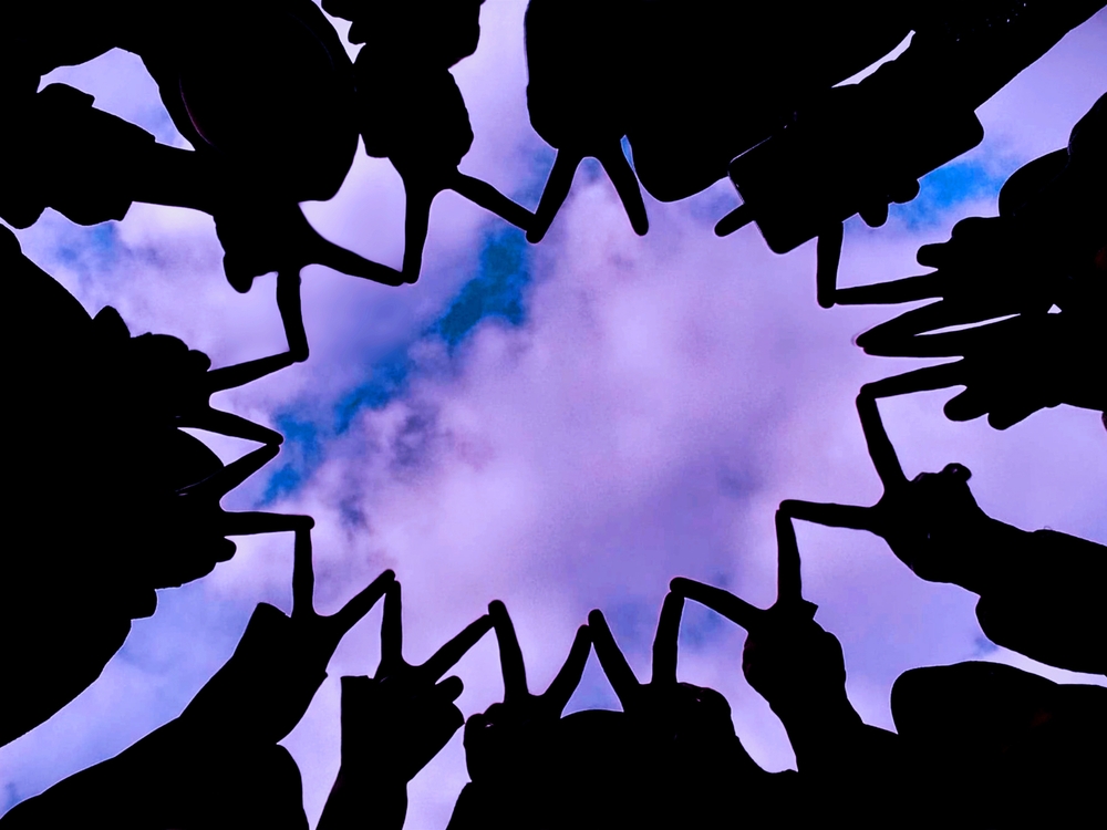 Hands forming the shape of v in a circular way