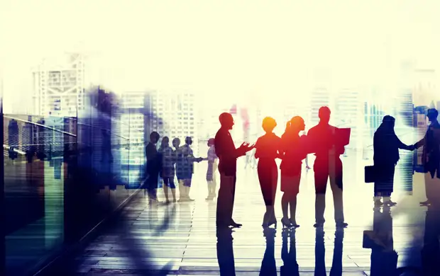 People outside an office with city landscape behind