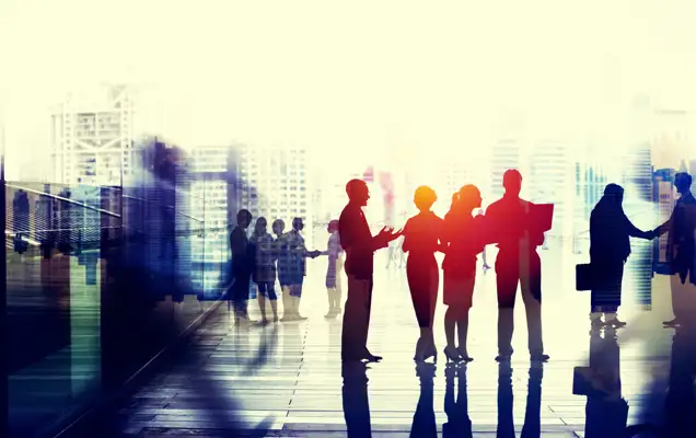 People outside an office with city landscape behind